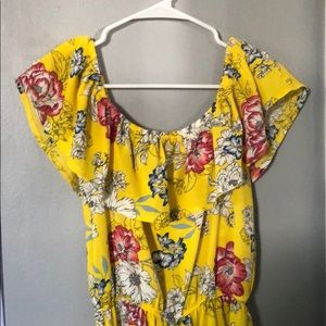 Yellow off the shoulder romper with flowers.